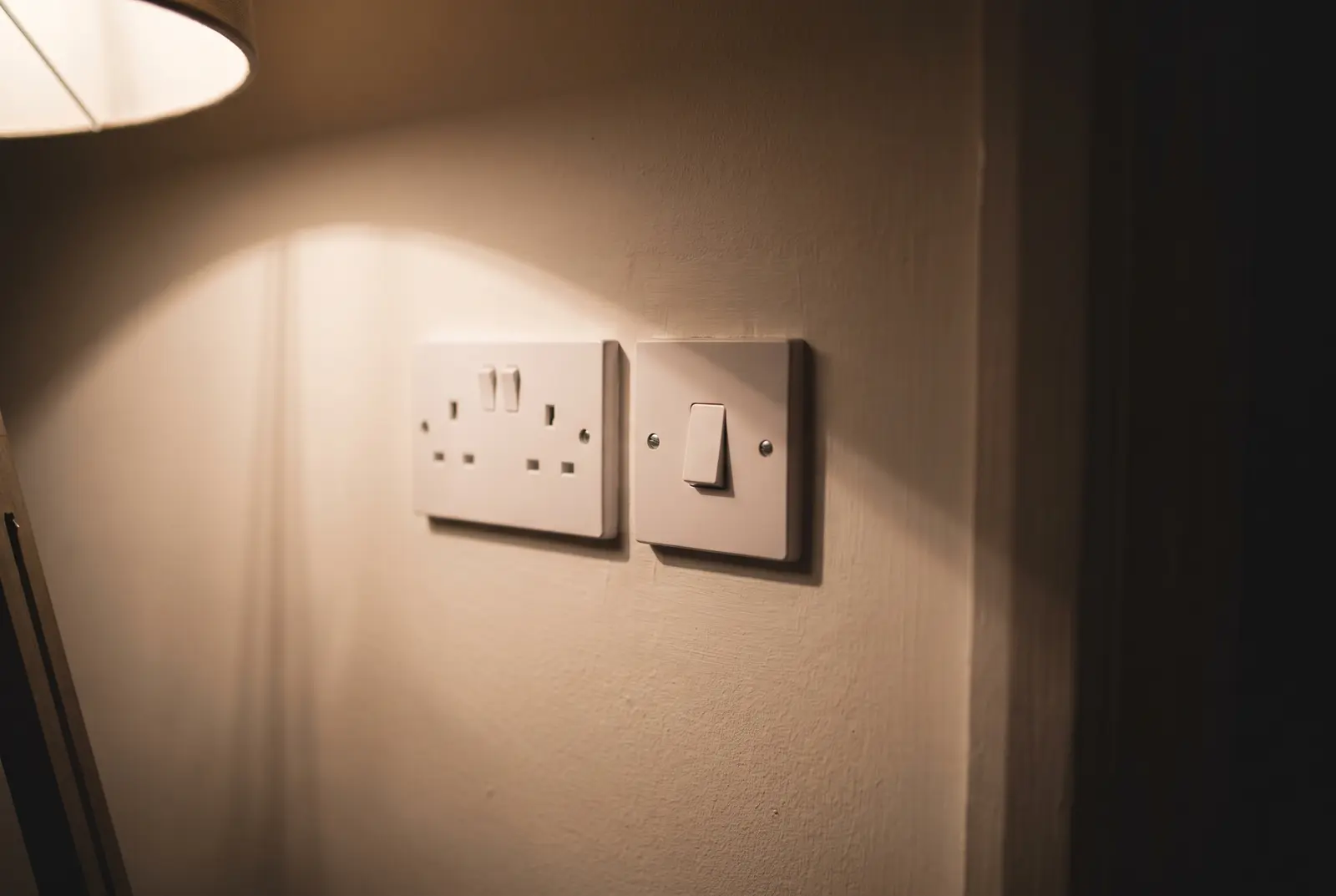 A newly fitted double socket and light switch, square and flush to the wall