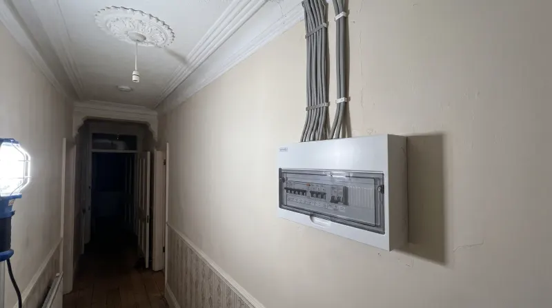 A modern consumer unit fitted in a Victorian hallway, examined on an emergency call-out in Bow