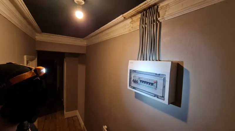A modern consumer unit fitted in a Victorian hallway, examined on an emergency call-out in Deptford