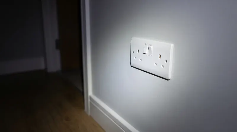A flush socket and switch plate in a modern flat, found by an emergency electrician in Stratford