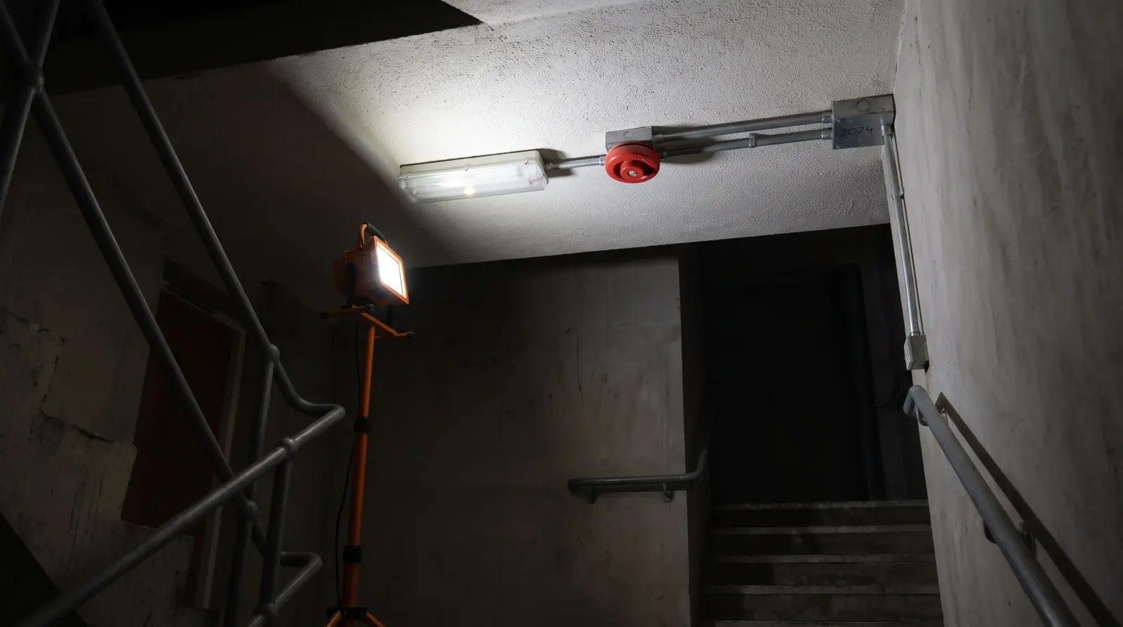 An emergency light and fire alarm sounder in a commercial stairwell — emergency lighting in Barkingside