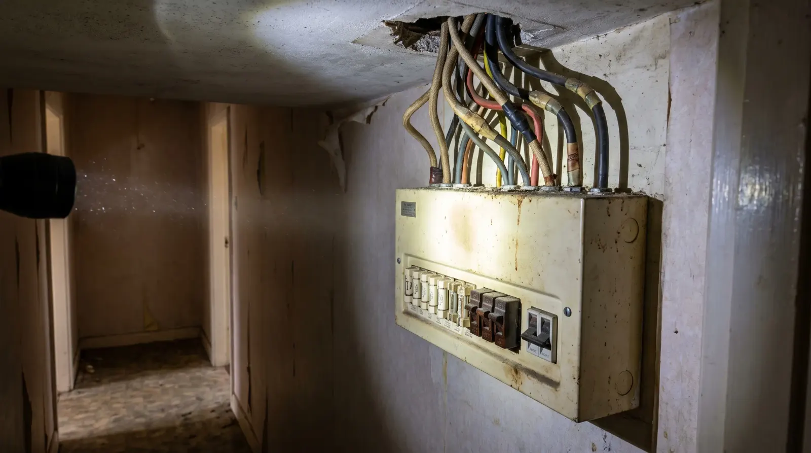 A consumer unit in the hallway of a postwar house — fuse board upgrade in Harlow
