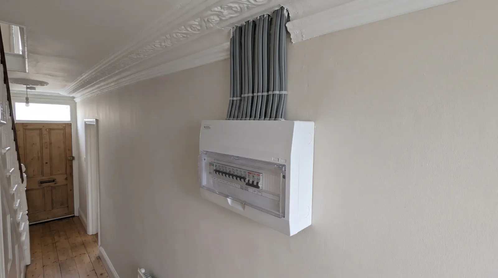 A modern consumer unit fitted in a Victorian hallway — the kind of fuse board upgrade an electrician in Highgate is called out for