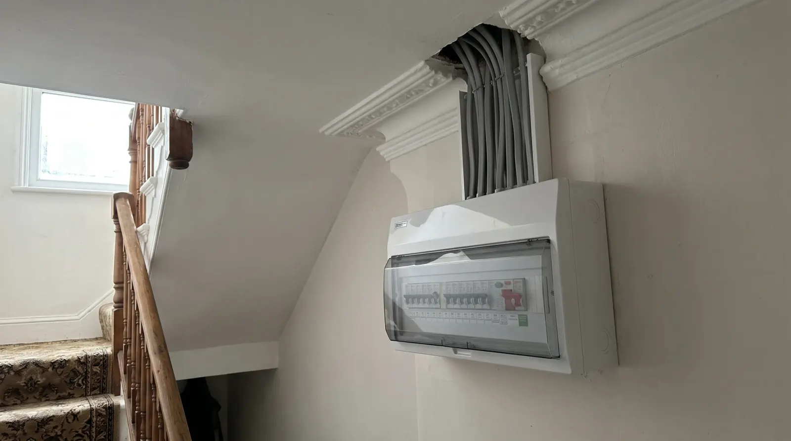 A modern consumer unit fitted in a Victorian hallway — the kind of fuse board upgrade an electrician in Plumstead is called out for