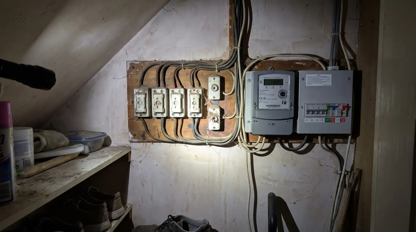 An original rewireable fuse box beside a newer meter — fuse board upgrade in Catford