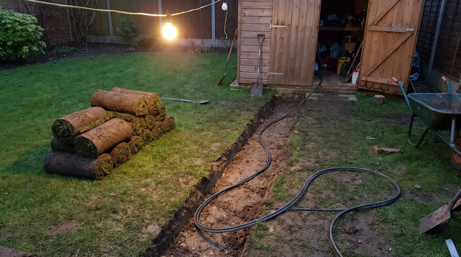 Armoured cable laid in a trench across a lawn to a garden office — the kind of garden office power supply an electrician in Abbey Wood is called out for