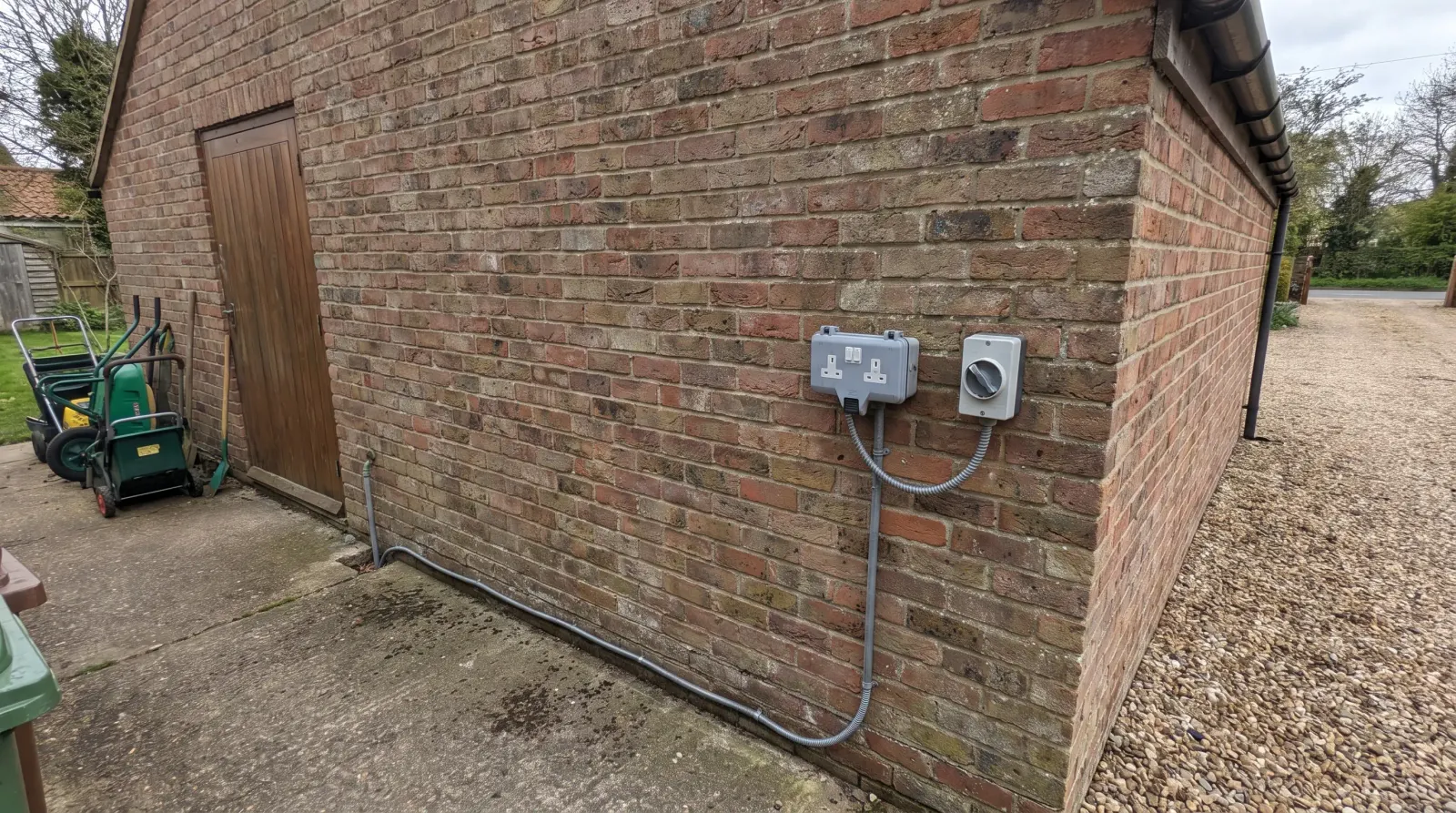 A weatherproof outdoor socket and isolator on a garage wall — outdoor sockets in Chigwell