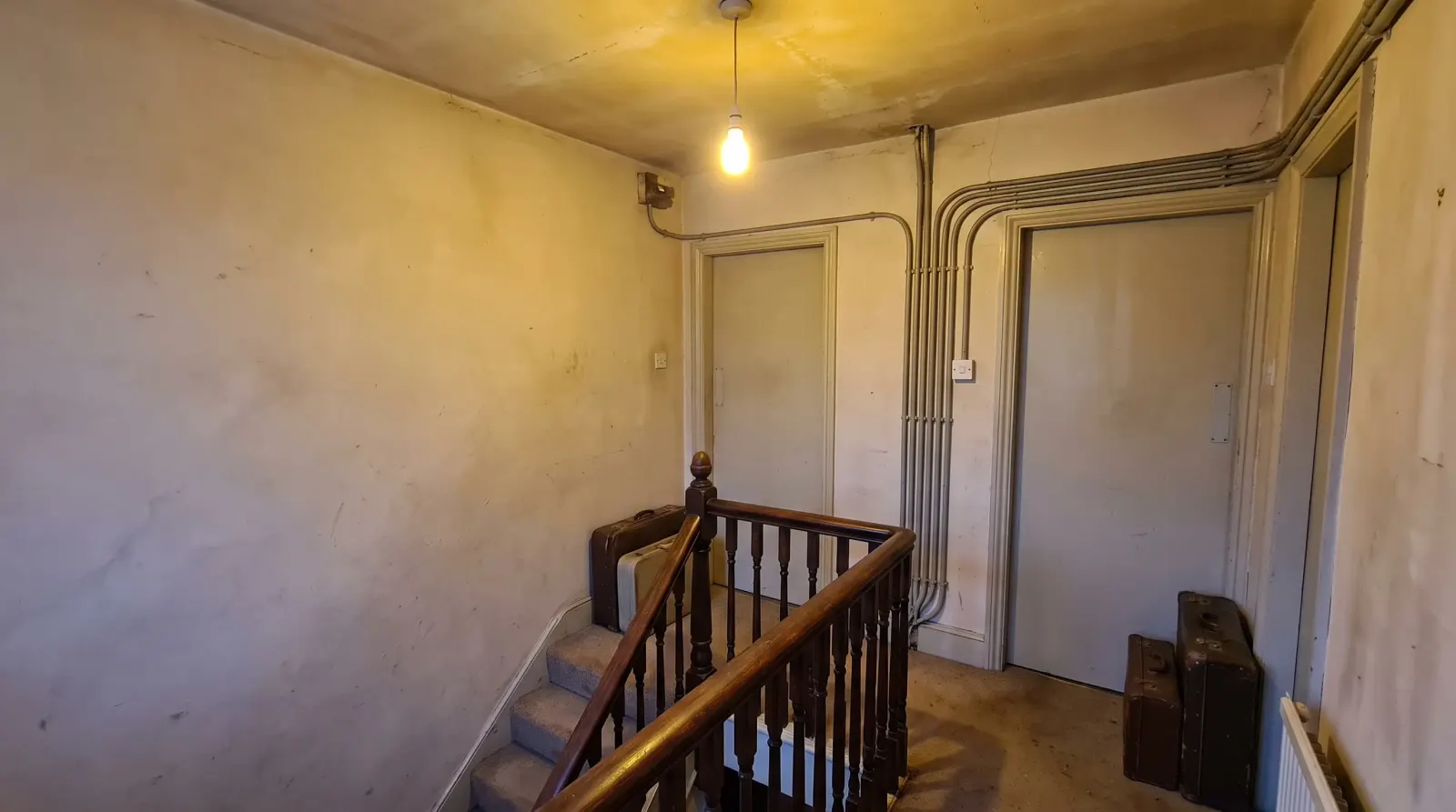 Surface-run cable to separate flat entrances on a landing — the kind of rewiring an electrician in New Cross is called out for