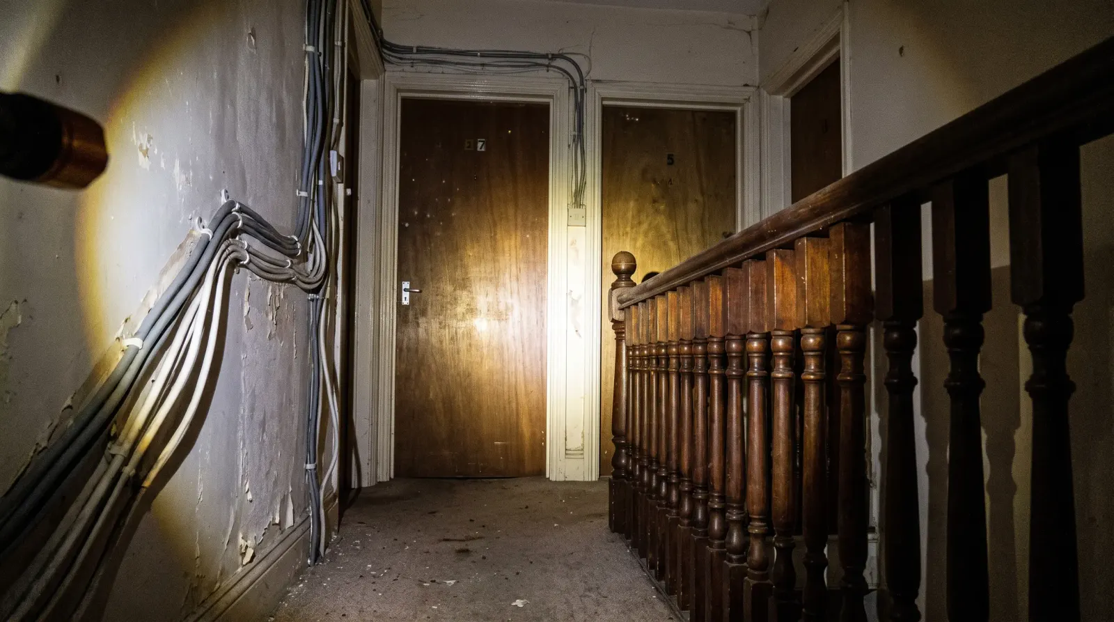 Surface-run cable to separate flat entrances on a landing — rewiring in Wood Green