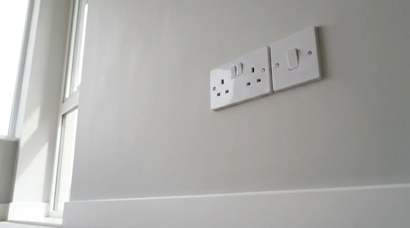 A flush socket and switch plate in a modern flat — new sockets and lighting in Isle of Dogs