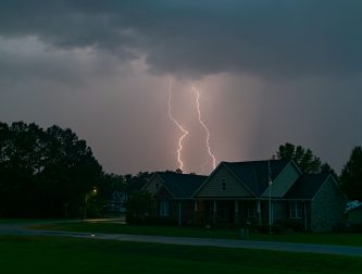 Lightning strikes over a suburban London street during a night thunderstorm