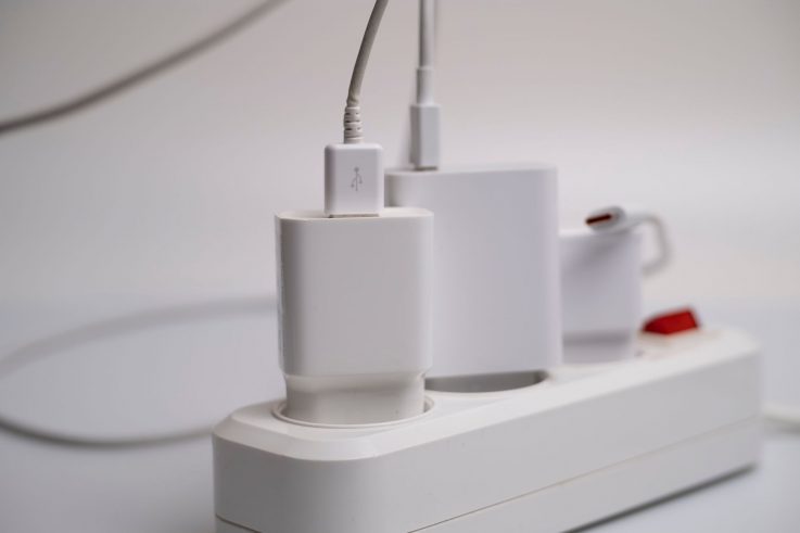 Multiple chargers crammed into one power strip, a common overloaded-socket fire risk