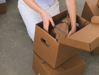 Person packing boxes while moving into a new rented home in London